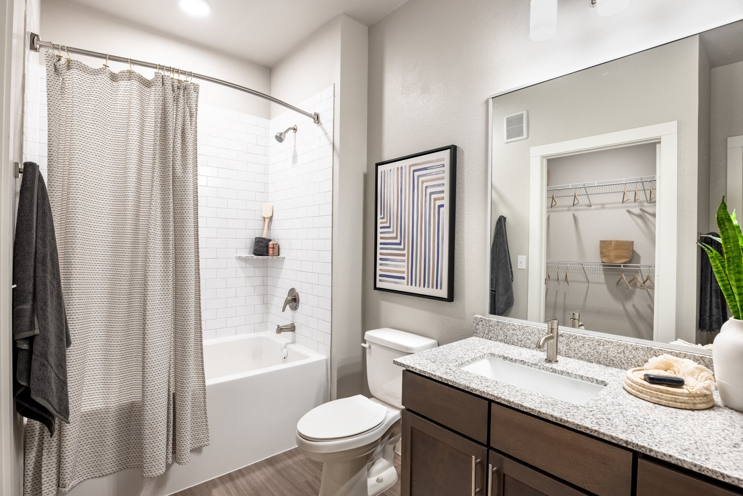 apartments bathroom with tub shower and sink and toilet